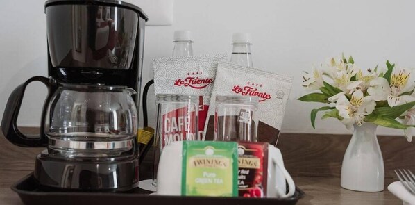 A coffee maker, tea packets, and a vase with flowers on a tray. - Gamma Chapala (Chapala)