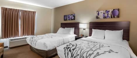 A hotel room with two beds, a large window with curtains, an air conditioning unit, a wall-mounted artwork, and a nightstand with a lamp.