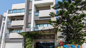 Un edificio moderno de varios pisos, con balcones y ventanas amplias.