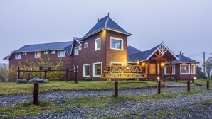 A wooden building with a sign reading "Patagonia Travellers' Hostel."