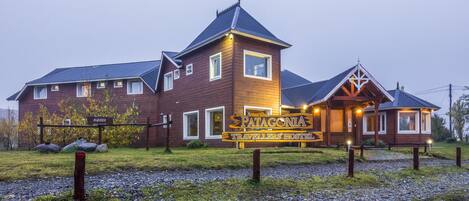 Un edificio de madera con un letrero que dice "Patagonia Travellers' Hostel".
