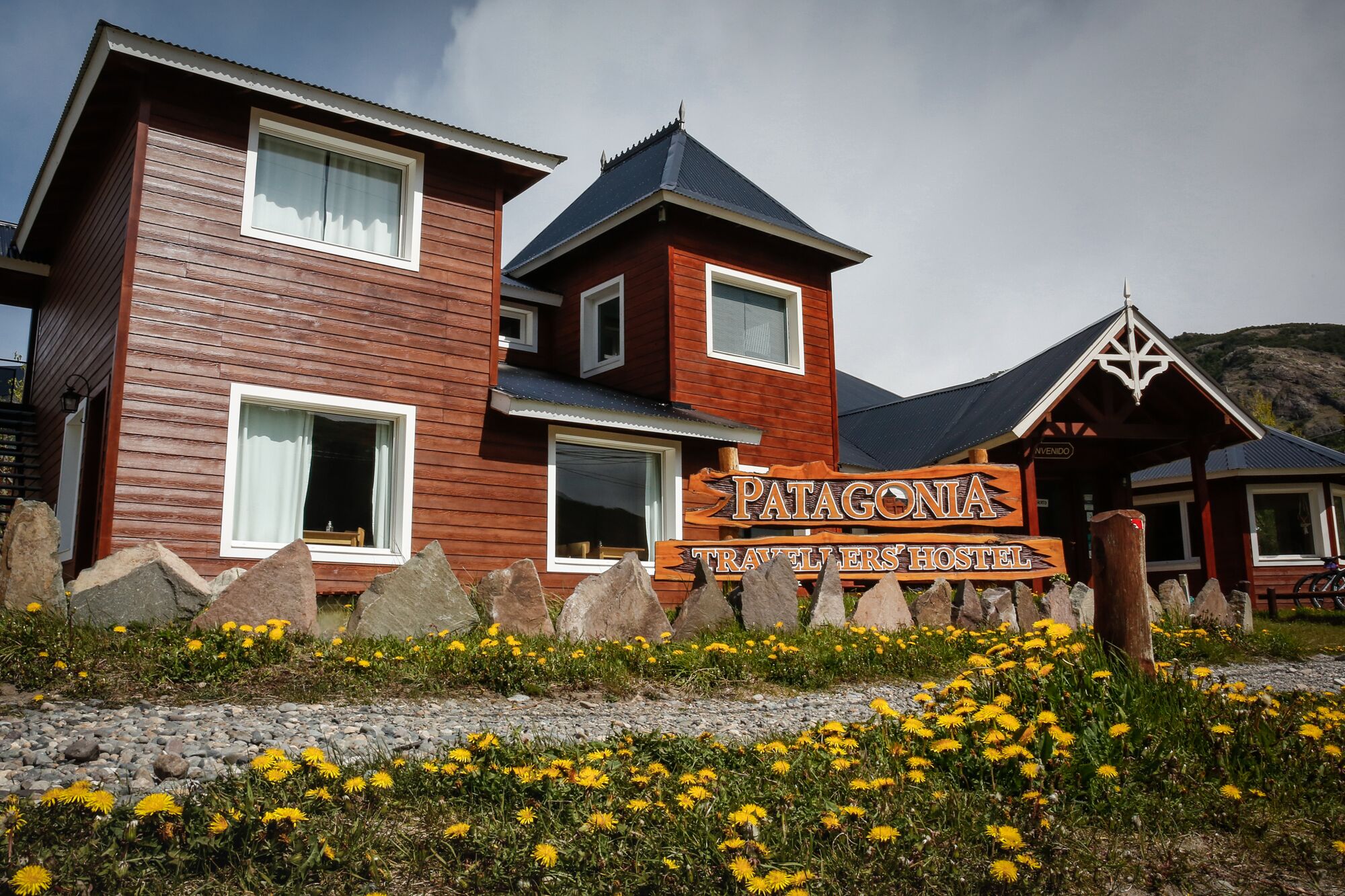 A wooden building with a sign reading "Patagonia Travellers Hostel".