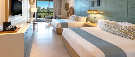 A hotel room with two beds, a TV, a balcony, and a dining area.