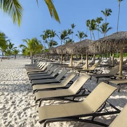 On the beach, white sand, sun-loungers, beach umbrellas