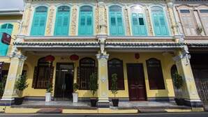 A traditional building with multiple windows, a tiled entrance, and decorative columns. - Aava Malacca Hotel (Malacca City)