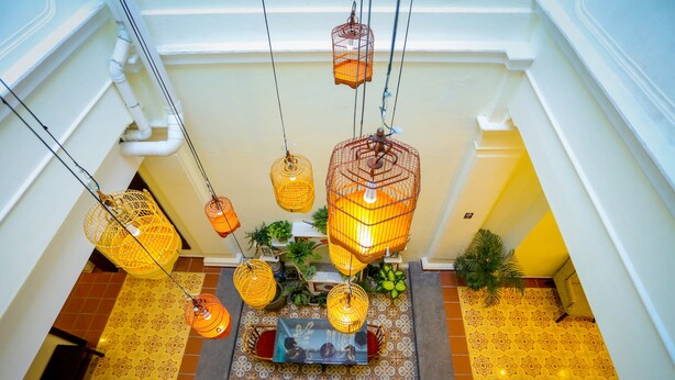 A staircase with hanging wicker lamps and patterned floor tiles. - Aava Malacca Hotel (Malacca City)