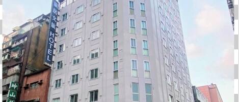 A multi-story hotel with a modern facade, featuring a prominent sign for the 'Hub Hotel.'