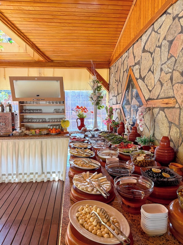 A buffet setup with various food items and a decorative mirror.