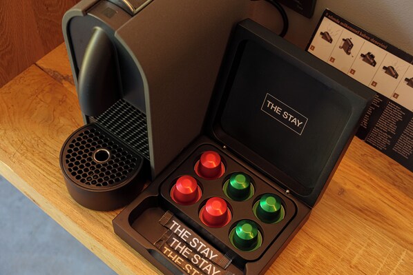 A coffee machine with a compartment containing four buttons, one of which is labeled 'THE STAY.' - Warehouse By The Stay (Cesme)