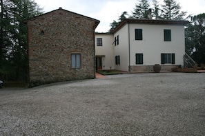 A two-story building with a stone facade and a white upper level.