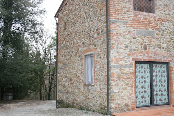 A stone building with a window and a door.