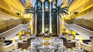 A grand lobby with a marble floor, elegant furniture, and a central decorative table. - Ezdan Palace Hotel (Doha)