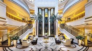 A grand lobby with a central seating area, multiple staircases, and large windows. - Ezdan Palace Hotel (Doha)