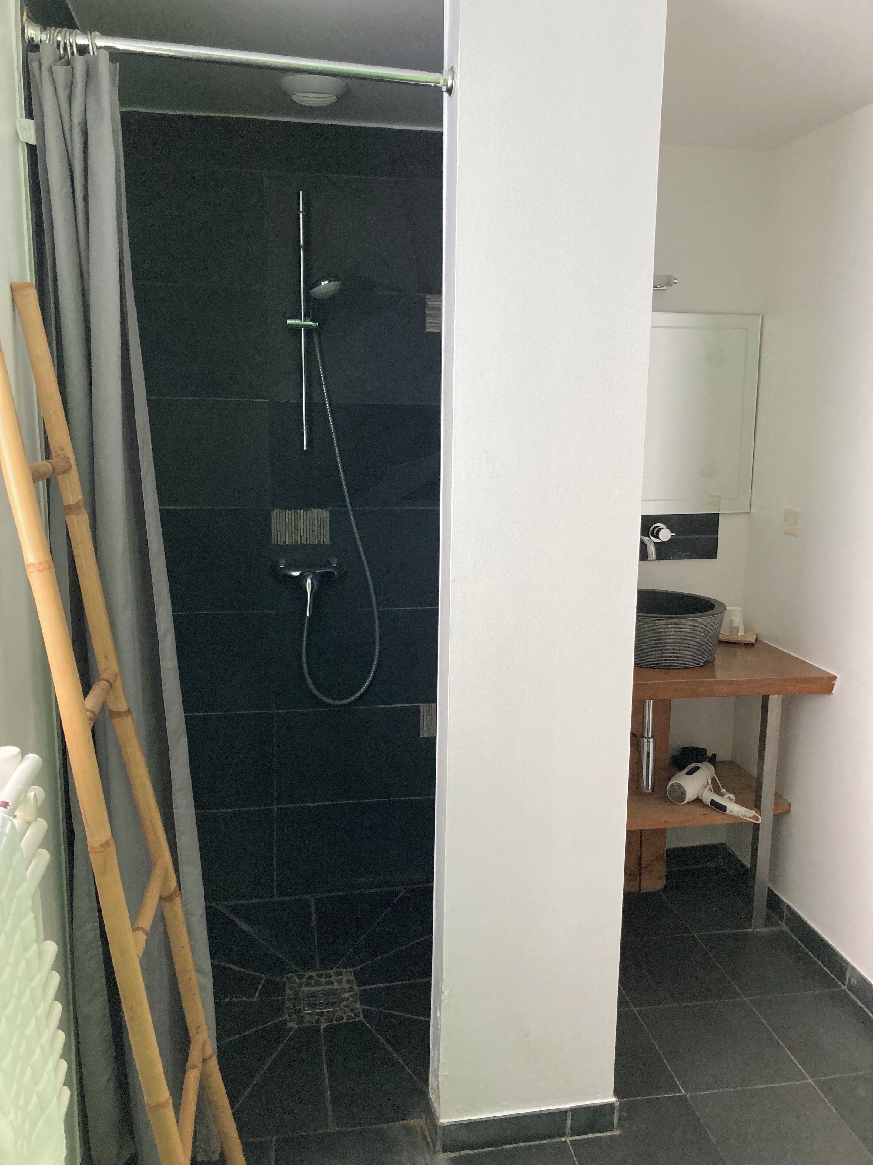 A bathroom with a shower, a toilet, and a sink.