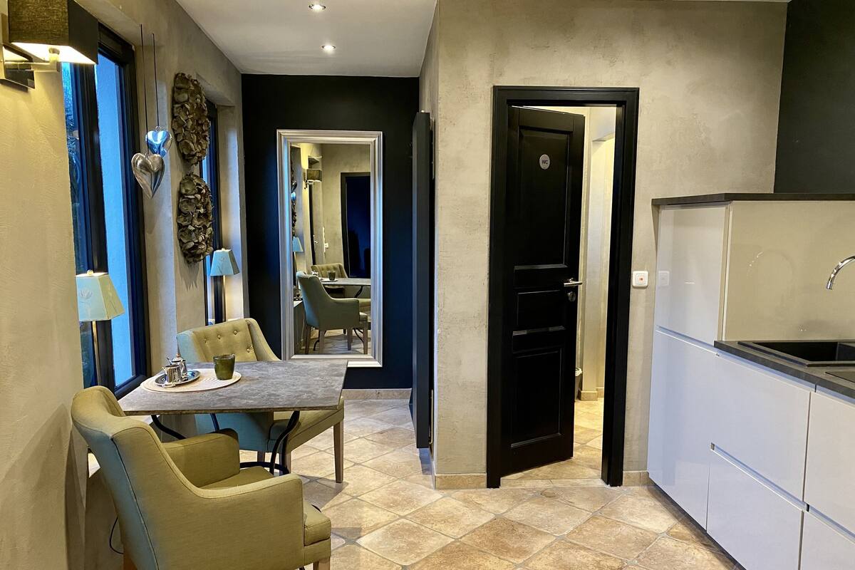 A modern kitchen with white cabinets, a built-in oven, and a sink.