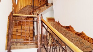 A wooden staircase with a stone wall and metal railing. - Plitvice Green Valley (Plitvicka Jezera)