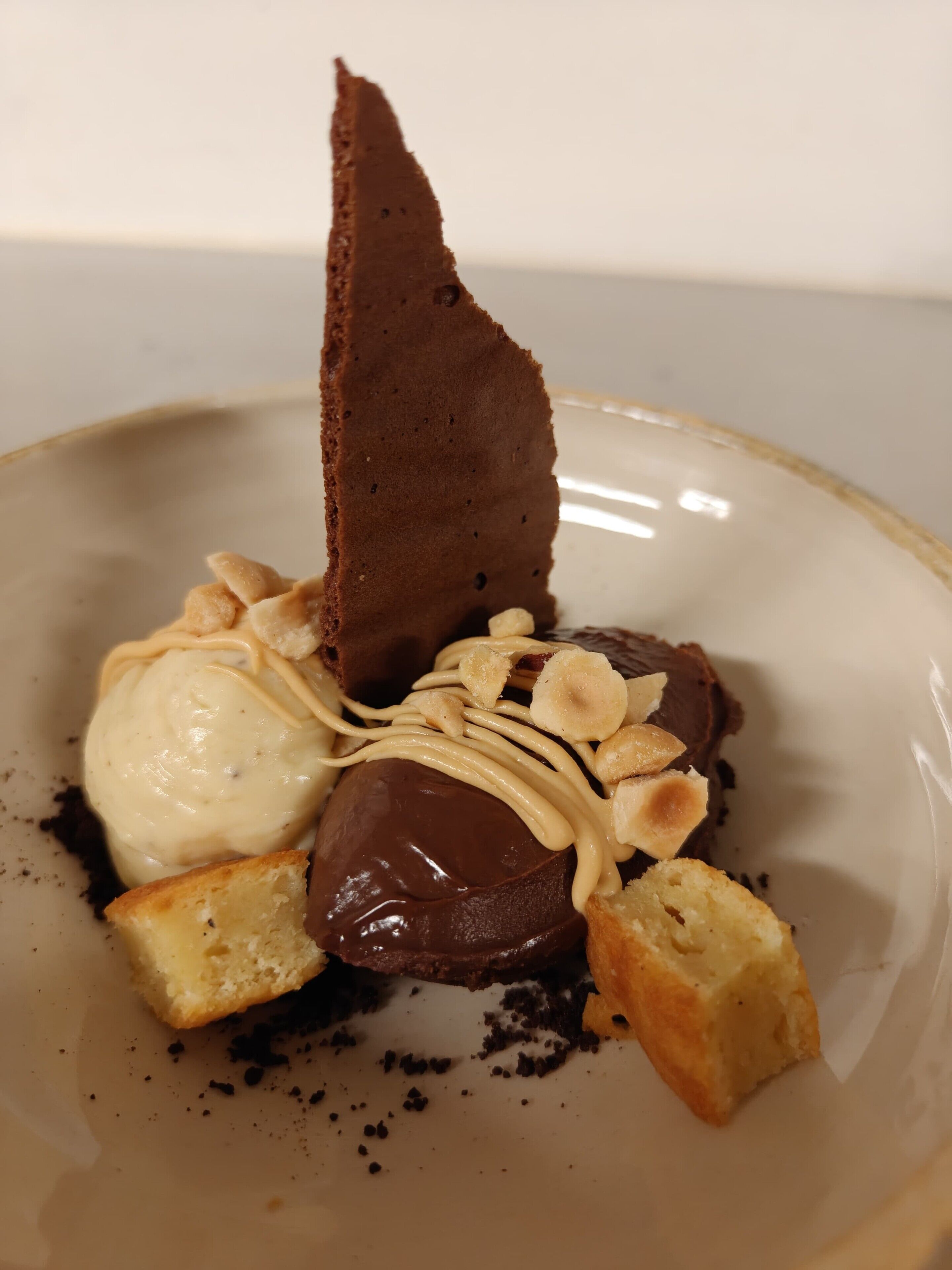 Ein Dessertteller mit Schokoladestückchen, Eiscreme und Mandelblättchen.