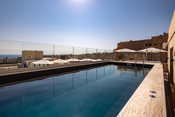Seasonal outdoor pool, pool umbrellas, pool loungers