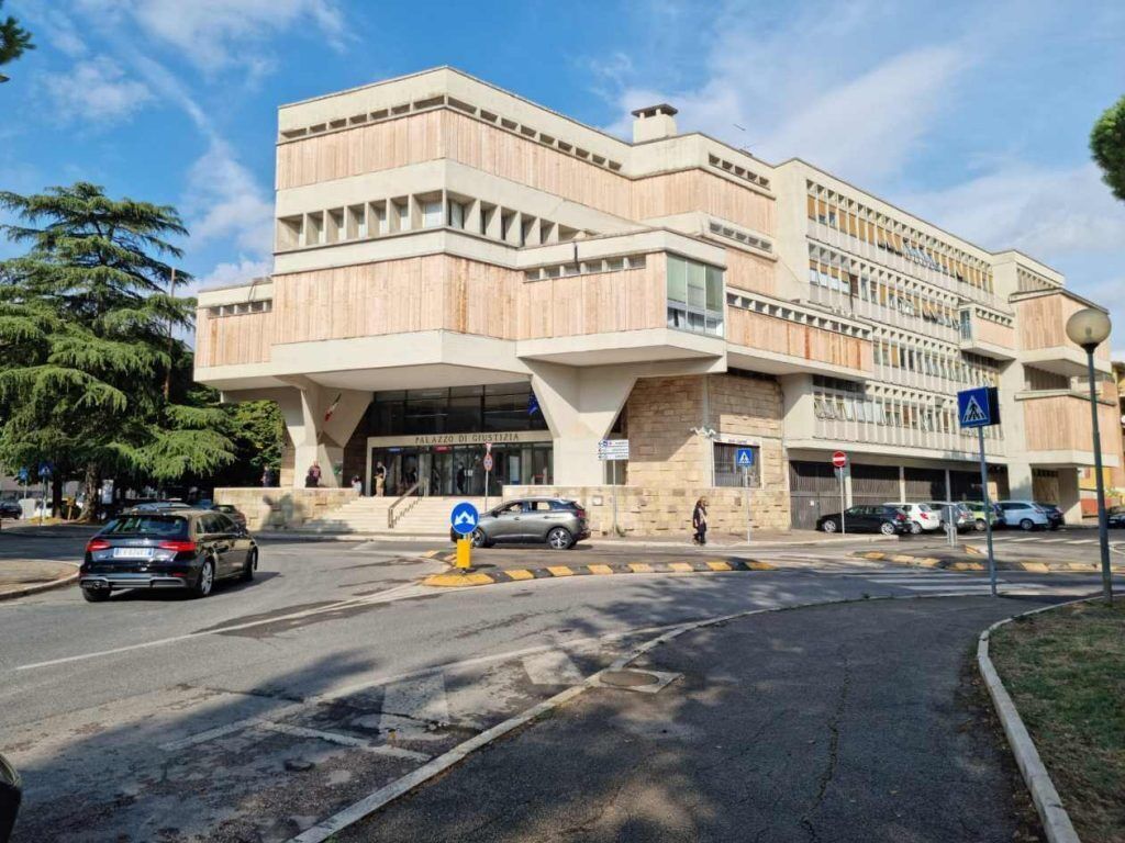 A modern building with a unique architectural design, featuring a prominent entrance and multiple levels.