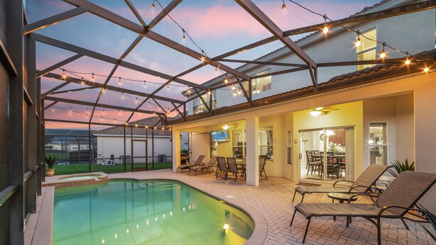 A swimming pool with a glass ceiling, lounge chairs, and a patio area with tables and chairs. - Awesome! 6BR 4BA Luxury, Games, 2 Waterslides (Four Corners)