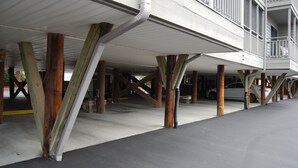 A parking garage with concrete floors and wooden support beams. - Great View w/o Oceanfront Prices-3BR 2.5BA -  (Myrtle Beach)