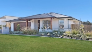 A modern two-story house with a garage, large windows, and a well-maintained lawn. - Best Cellar - The VIntage Holiday Houses (POKOLBIN)