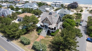 An aerial view of a residential area with houses, a road, and a beach in the background. - Nantucket Charm | 280 ft from the Beach | Private Pool (Virginia Beach)
