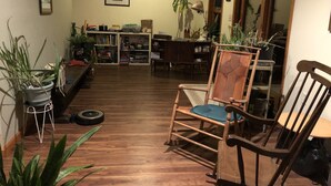 A cozy living room with wooden flooring, a rocking chair, and various plants. - Beautiful valley views & next to Big Spring State Park (Doylesburg)