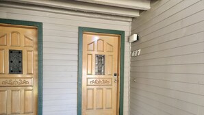 A wooden front door with a green frame, a small window with decorative glass, and a number '617' on the wall. - Snowcreek Resort Vacation Rental 617 (Mammoth Lakes)