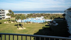 A resort with a pool, palm trees, and a beach view. - Completely Remodeled Direct Ocean View Colony Reef Condo 3401 (St Augustine)