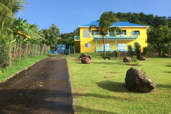Road side view of Casa Calypso.. The LEEWARD apartment is on lower level