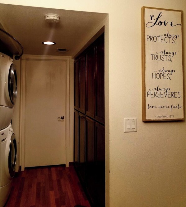A laundry room with a washing machine, a dryer, and a wooden floor. - beautiful home Sleeps 8, but 6 comfortably (Yuma)