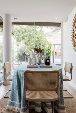 A dining area with a table set for two, featuring rattan chairs and a tablecloth. - SEA, GOLF, RELAX, LANDSCAPE, POOL (Rincón de la Victoria)