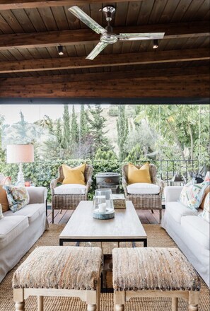 A cozy outdoor seating area with wicker furniture, a wooden ceiling fan, and a view of lush greenery. - SEA, GOLF, RELAX, LANDSCAPE, POOL (Rincón de la Victoria)