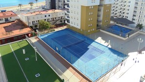 A multi-story hotel with a rooftop pool, a beach view, and a fortified building in the background. - R. Peñiscola Beach 540 LEK (Peñiscola)
