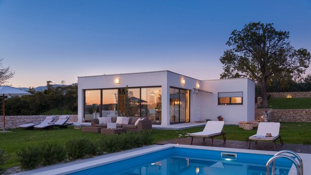 A modern house with a swimming pool, outdoor seating, and a stone wall. - Luxury Villa In Split, Few Minutes To Center, Beaches, Shopping, Sport Courts (Split)