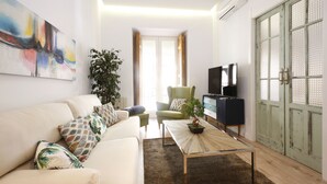 A modern living room with a sofa, coffee table, and television.