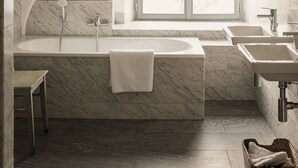 A modern bathroom with a freestanding bathtub, a window with a view, and a vanity with a sink. - Apartment Gut Üselitz on Rügen - 1. First floor left (Poseritz)