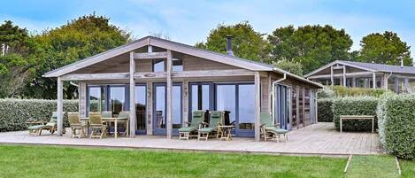 Relax on the covered patio with comfortable seating and enjoy the views of the surrounding greenery.
