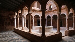An interior courtyard with arches, columns, and a central fountain. - Estudio 7 (Miami Playa)