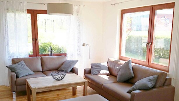 A living room with two sofas, a coffee table, and a floor lamp.