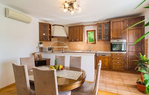 Kitchen features a microwave, stainless steel oven, and sink with modern faucet.