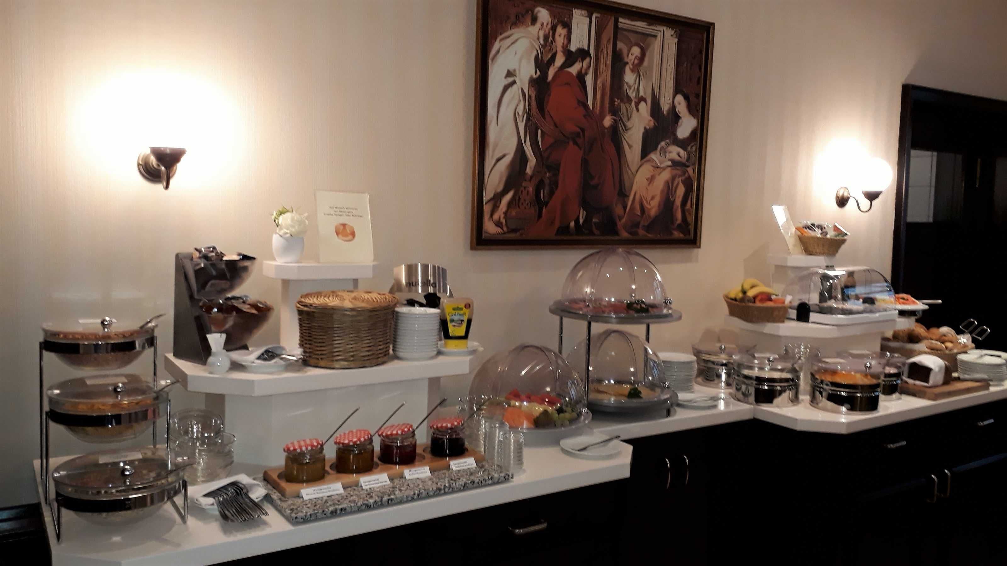 A buffet setup with various food items and condiments.