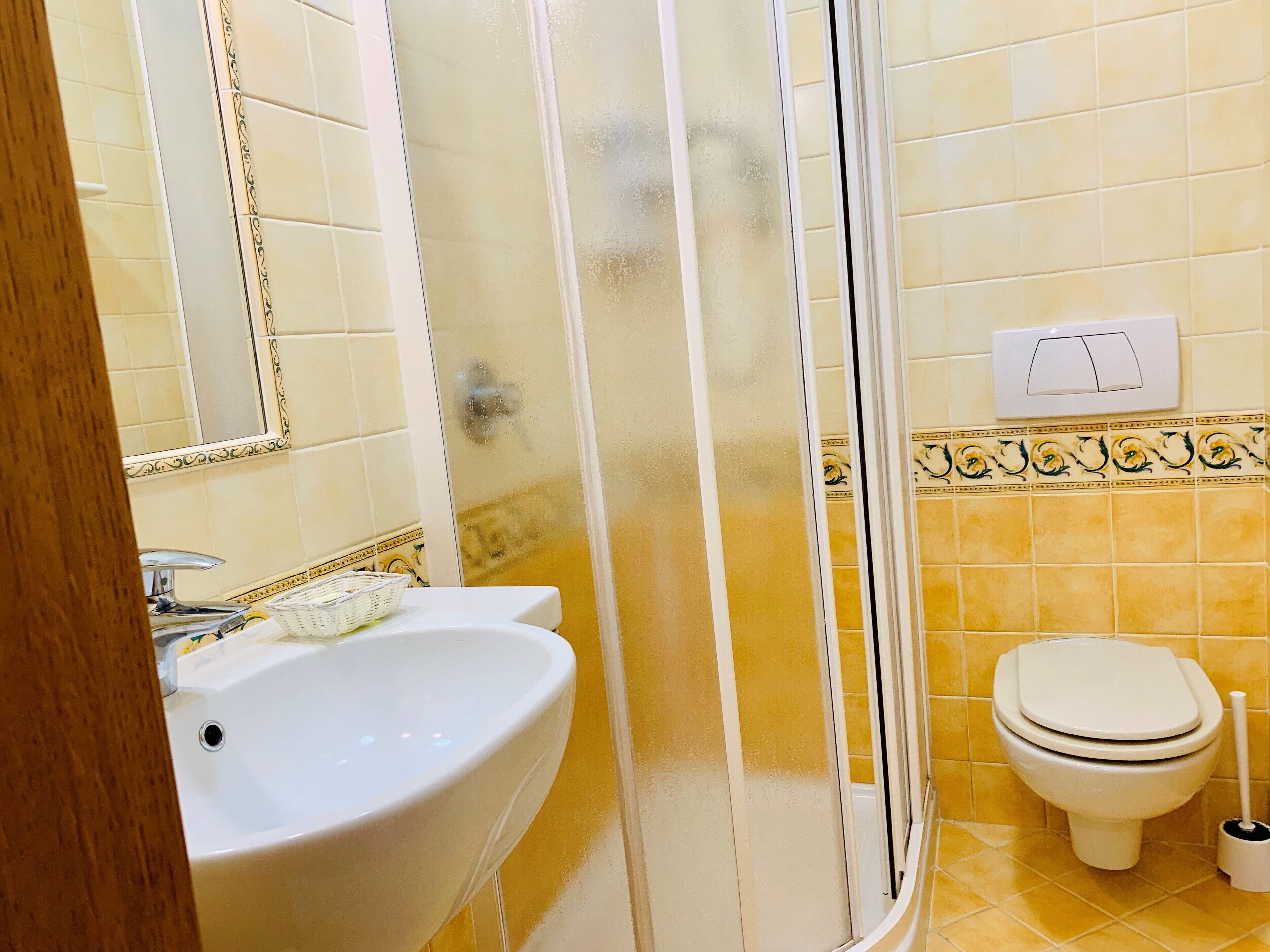 A bathroom with a sink, toilet, and shower.