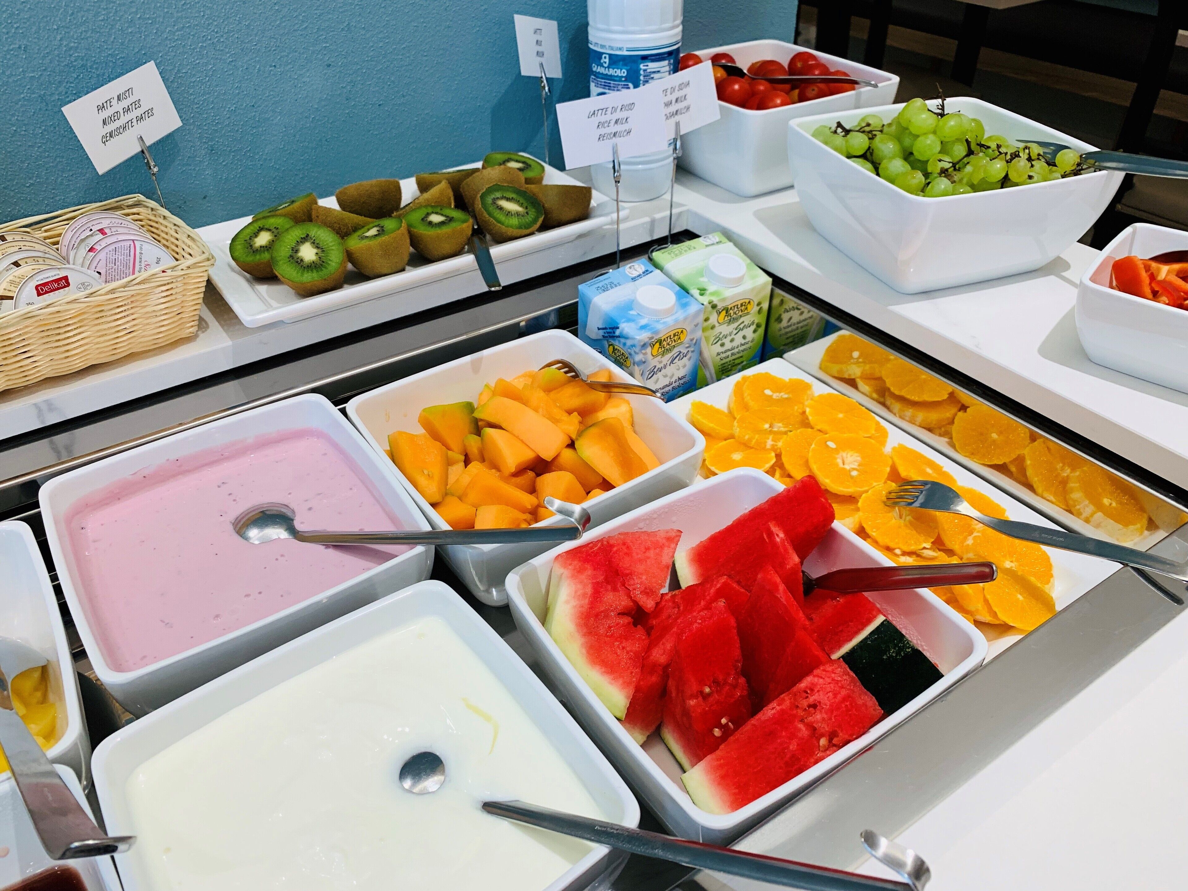 A buffet with various fruit and dairy options.