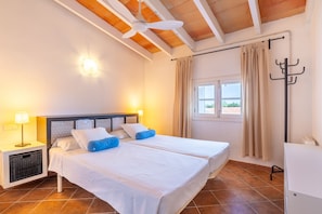 A hotel room with a bed, two bedside lamps, a ceiling fan, a window with curtains, and a coat rack. - 44250 Finca Es Estador (Manacor)