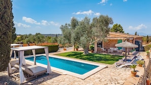 A pool area with lounge chairs and a stone patio. - 44250 Finca Es Estador (Manacor)