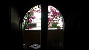 A view through a semi-circular window with a sign indicating a concierge service.