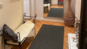 A narrow hallway with a bed, a mirror, a vase, and a small table. - Super * * * apartment at the main station with internet, washing machine (Berlin)