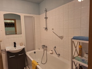 Bathtub, hair dryer, towels, soap